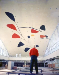 Calder reviewing the installation of .125, Idlewild Airport (now John F. Kennedy International Airport), New York, 1957