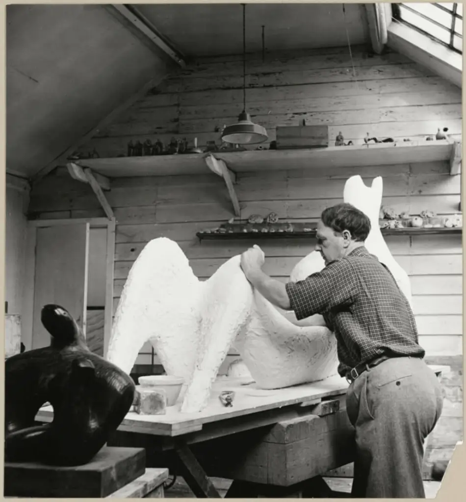 Henry Moore in his studio at Hoglands, Perry Green in Hertfordshire, working on ‘Reclining Figure’ for the 1951 Festival of Britain. © Historic England Archive.